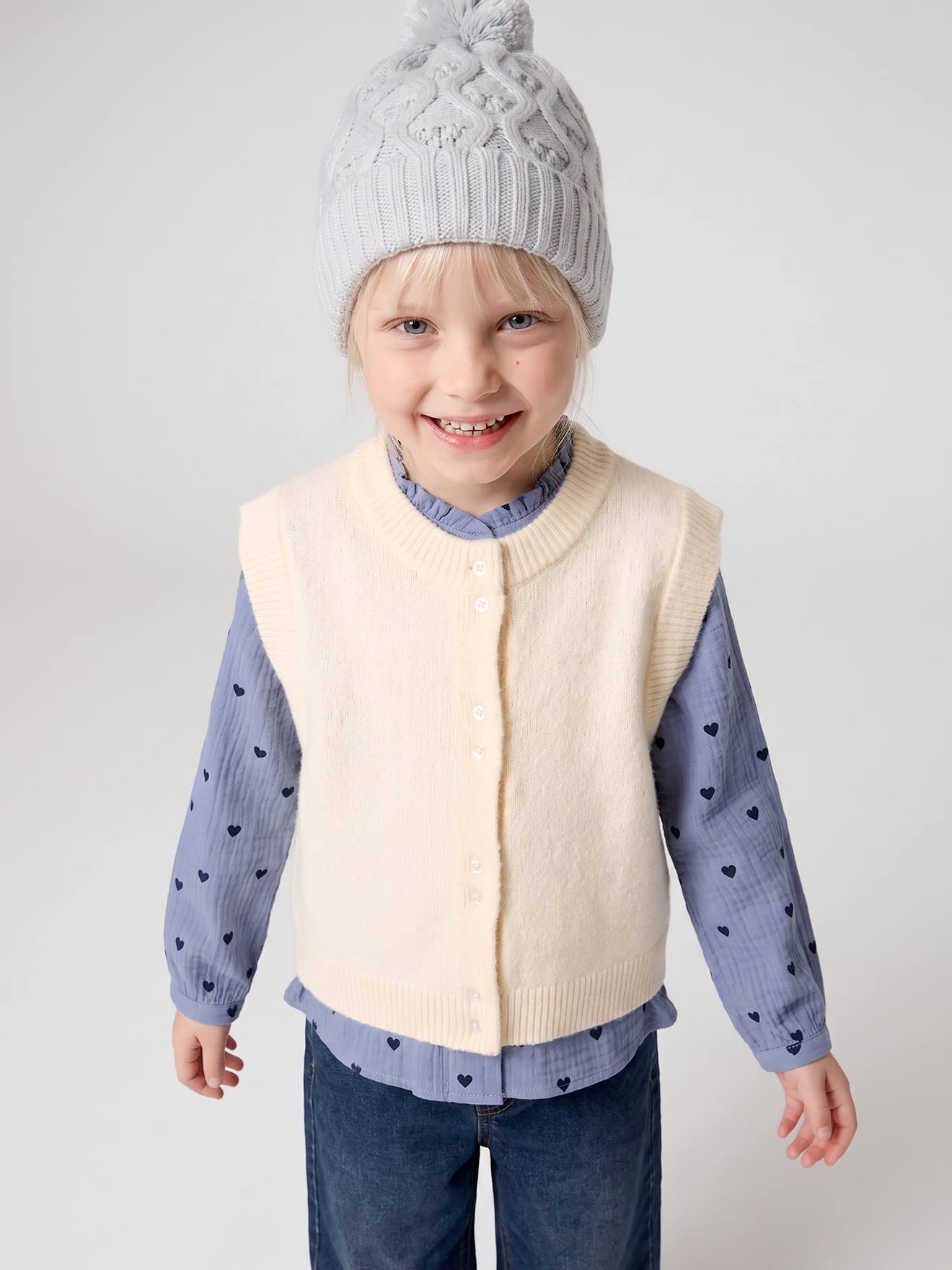 Mouwloos meisjesvest met knopen vanille